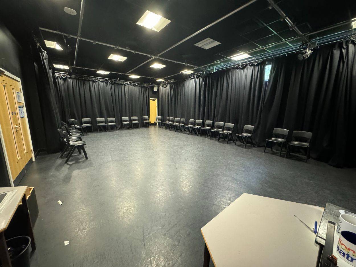 Black box drama rehearsal room shoot space with suspended ceiling lighting tracks in Barnet N12 through Love Locations.