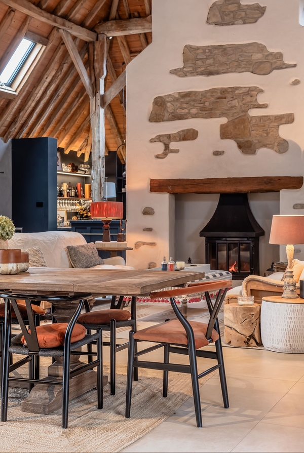 Central fireplace in a large open-plan barn via Love Locations.