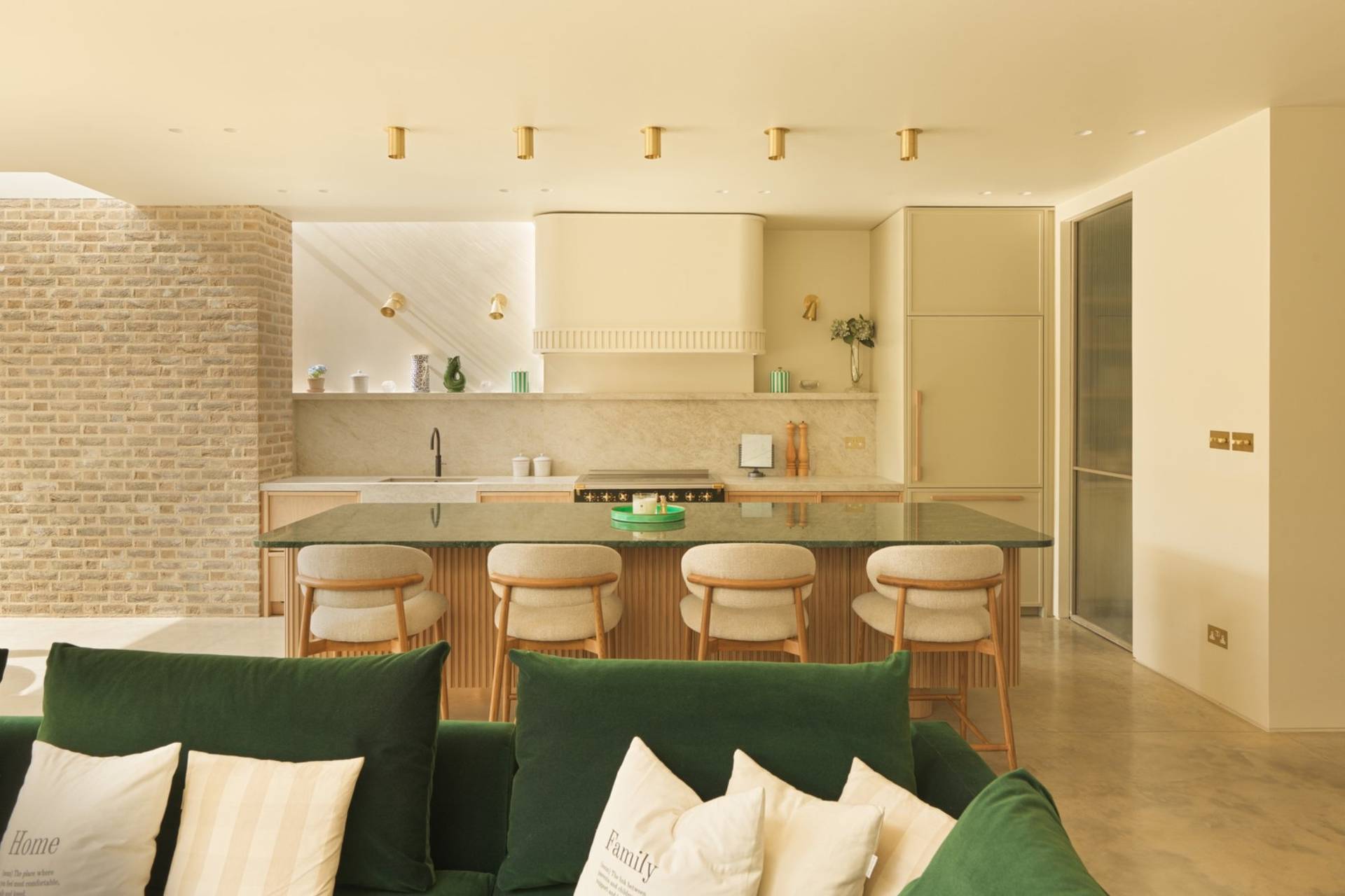 Sleek modern kitchen photo location with a green marble island top, neutral fitted cupboards, and soft recessed lighting through Love Locations.
