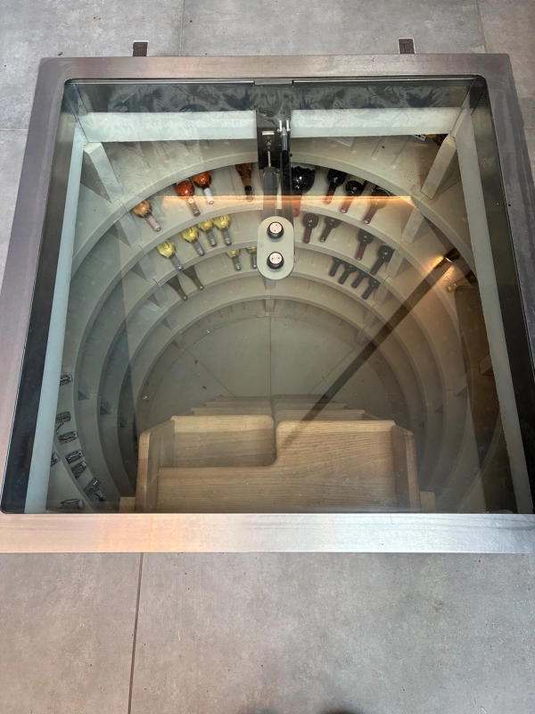 Unique spiral wine cellar with a glass floor door hatch inside a luxury location home in Essex CM4, available through Love Locations.