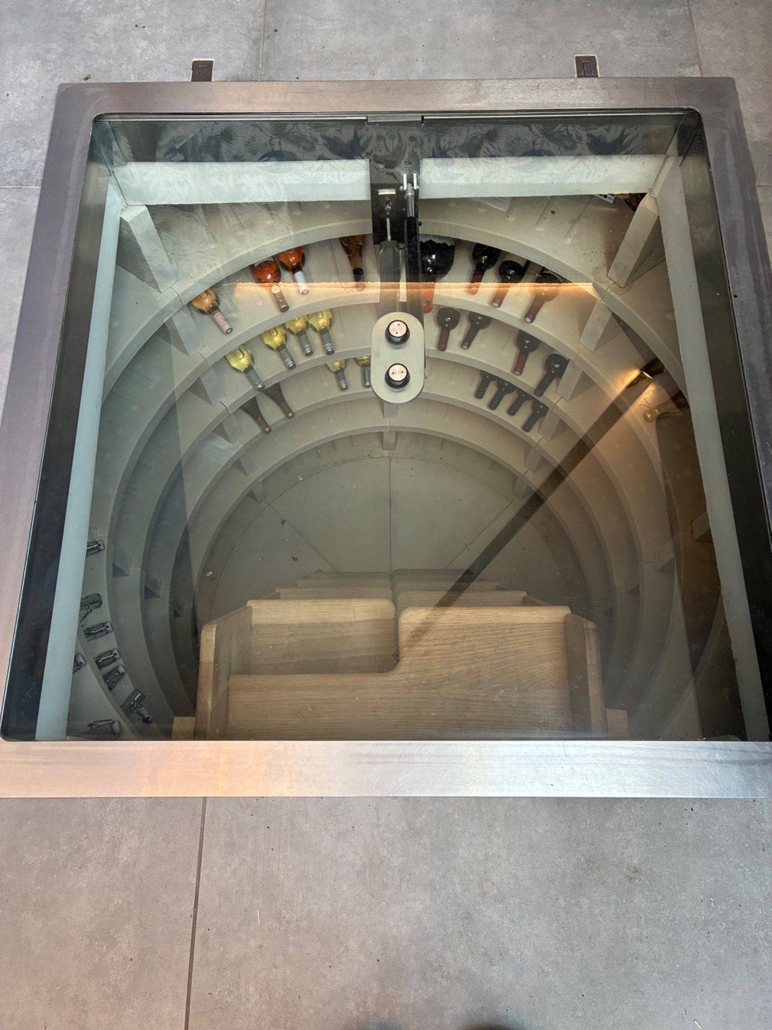 Unique spiral wine cellar with a glass floor door hatch inside a luxury location home in Essex CM4, available through Love Locations.