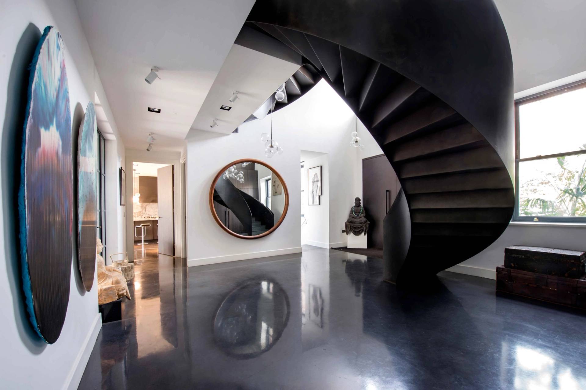 Dramatic spiral staircase and high-gloss flooring in a luxury North London home, perfect for high-end fashion lookbooks, Love Locations NW3.