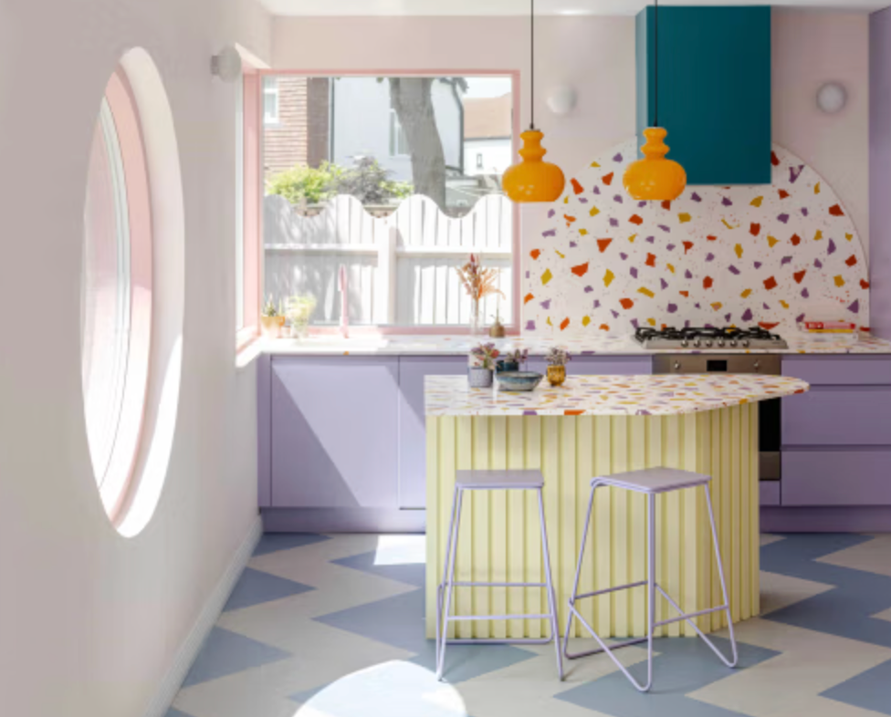 Pastel Memphis-inspired kitchen at Purple House with terrazzo surfaces, lilac cabinetry, ribbed island and playful colour palette.