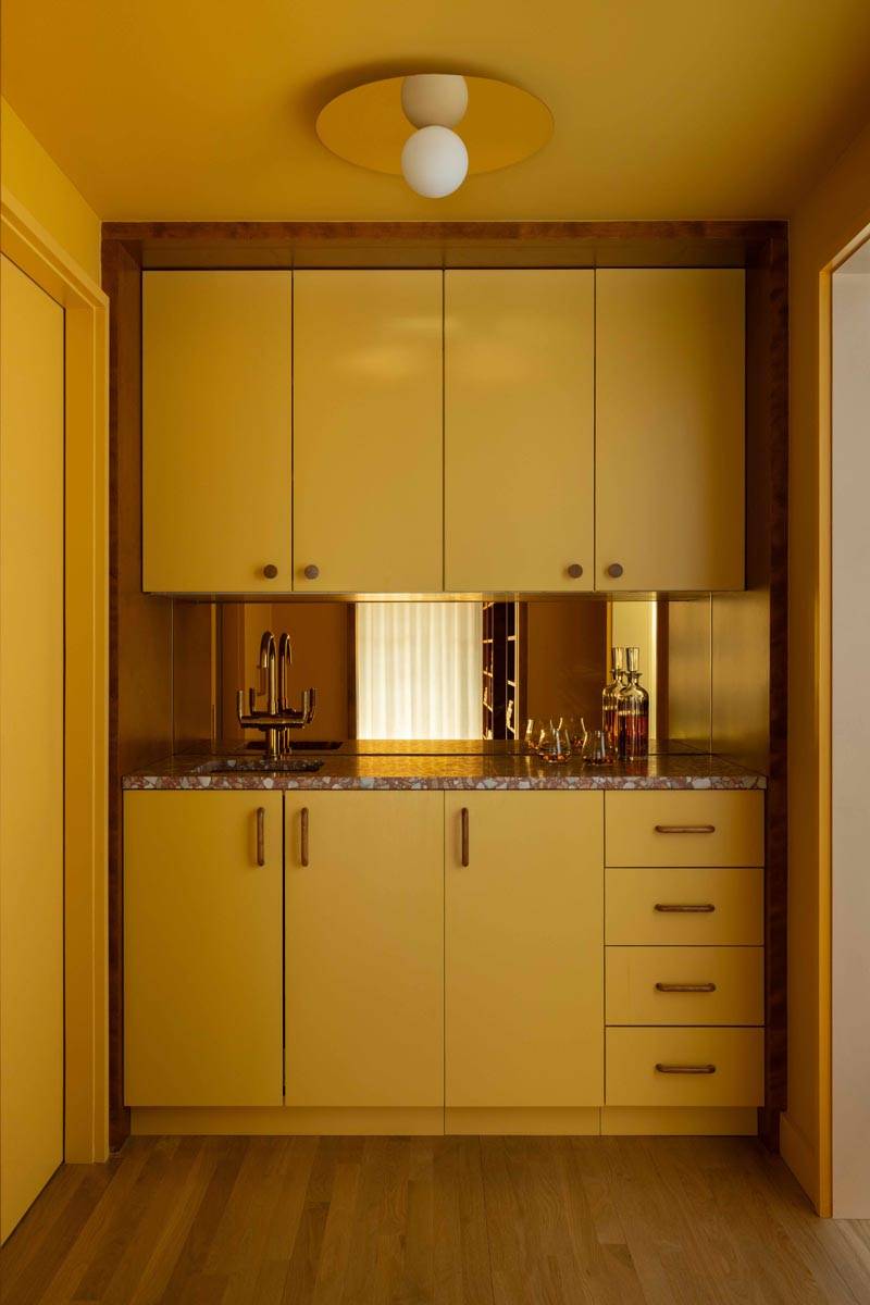 Custom yellow wood vanity and sink nook shoot space in a Boerum Hill townhouse location house from Love Locations.