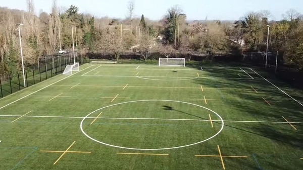 Love Locations outdoor sports pitch Reading: High-angle overview of a green 3G artificial turf football pitch with marked lines, tailored for sportswear campaigns and sports filming.