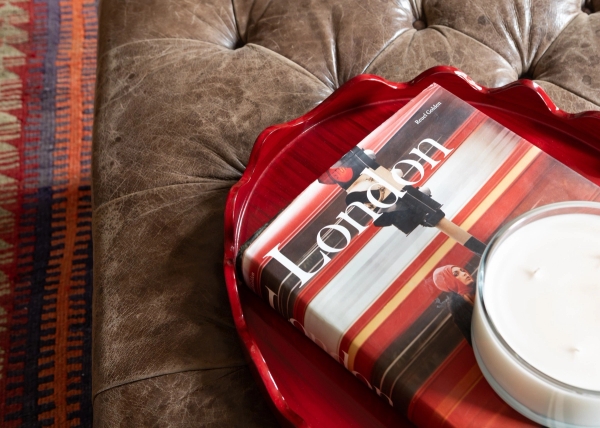 Editorial detail shot featuring a vintage coffee table book titled "London" resting on a classic leather sofa in a Westminster SW1V property by Love Locations.