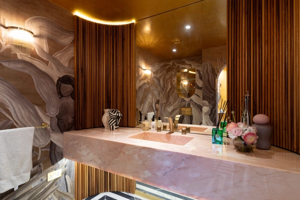 Love Locations pastel vanity location GU8: Stunning designer bathroom showcasing a solid pink marble floating sink counter below a seamless mirror, optimized for skincare brand filming.