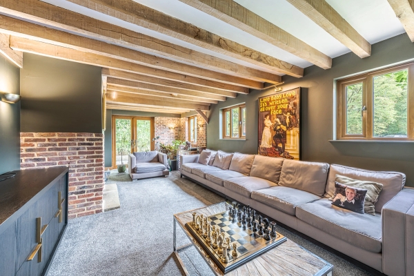 Lounge area with timber structure inside Essex barn, Love Locations