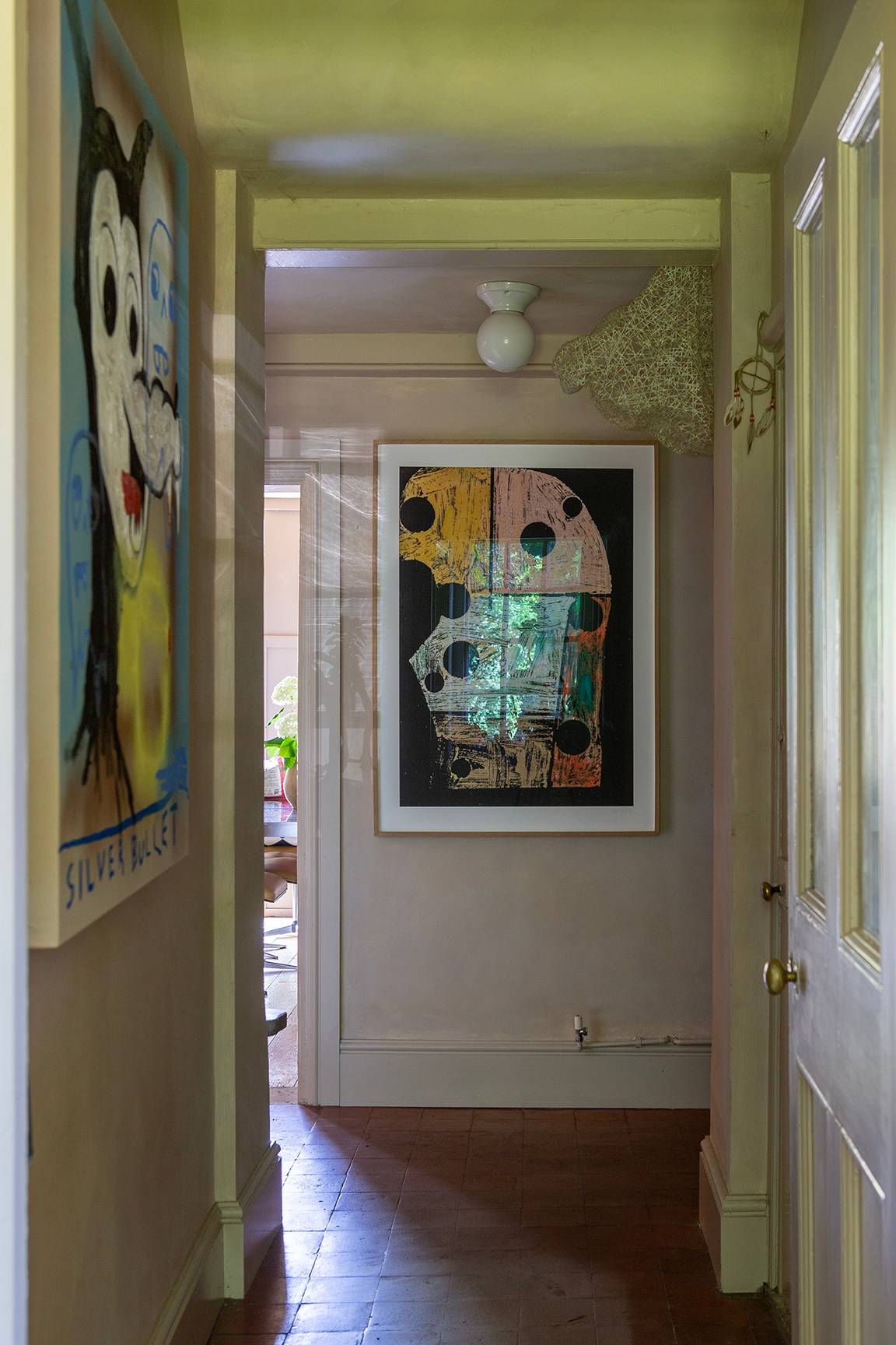 Bright hallway corridor featuring abstract wall paintings and white panelled doors, Love Locations ME13.