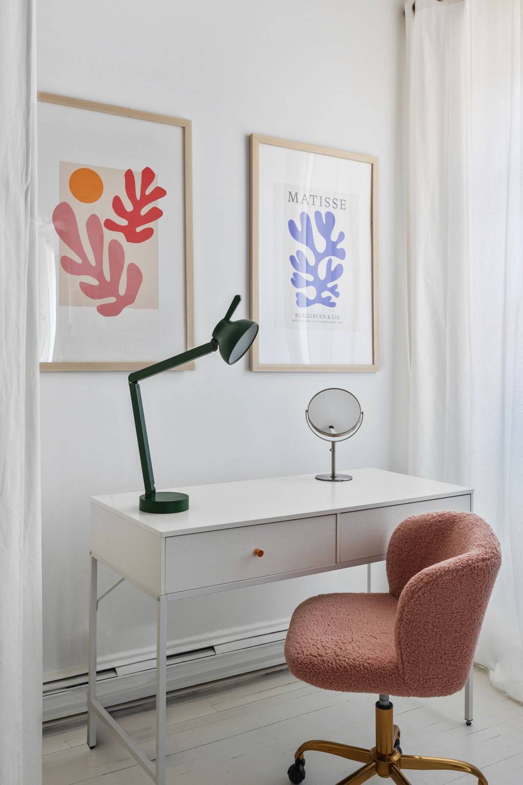 White study desk setup with a green desk lamp and pink velvet armchair in a Tribeca loft production space by Love Locations.