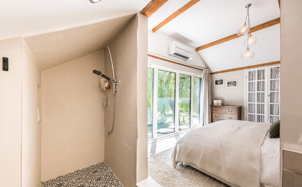 En-suite master bedroom layout showing an open-plan luxury walk-in shower room partition, curated by Love Locations.
