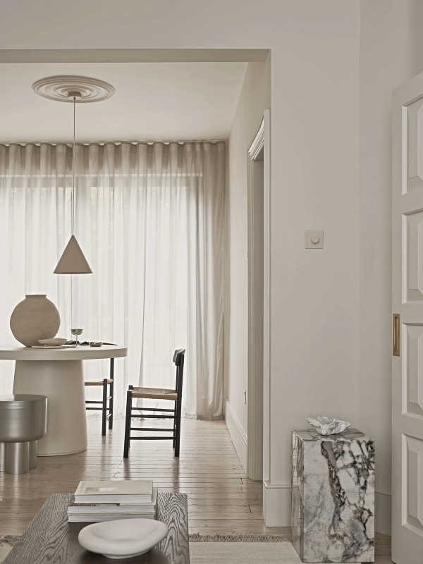 Bright East London living area with large windows and timber flooring