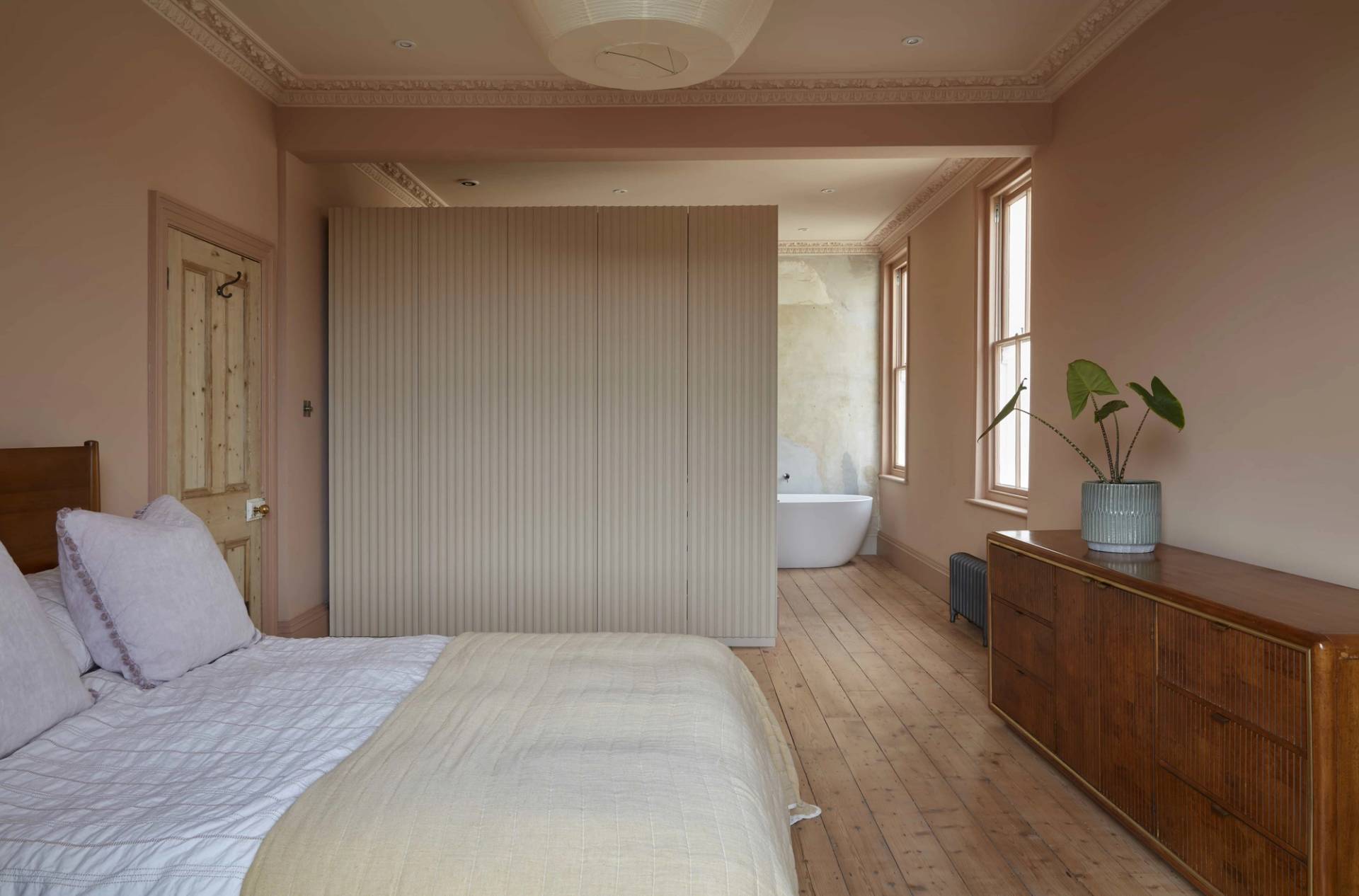 Spacious master bedroom suite featuring slatted wall dividers and an open ensuite bathroom, ideal for luxury lifestyle features, Love Locations TN34.