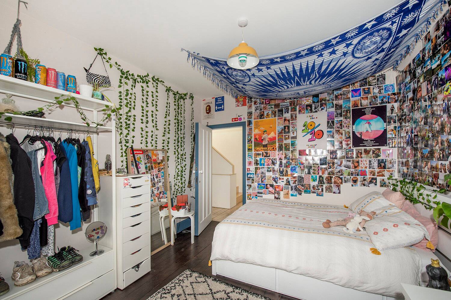 Creative youth bedroom featuring ivy leaf garlands, photo collage wall, and white storage furniture, Love Locations SE23.