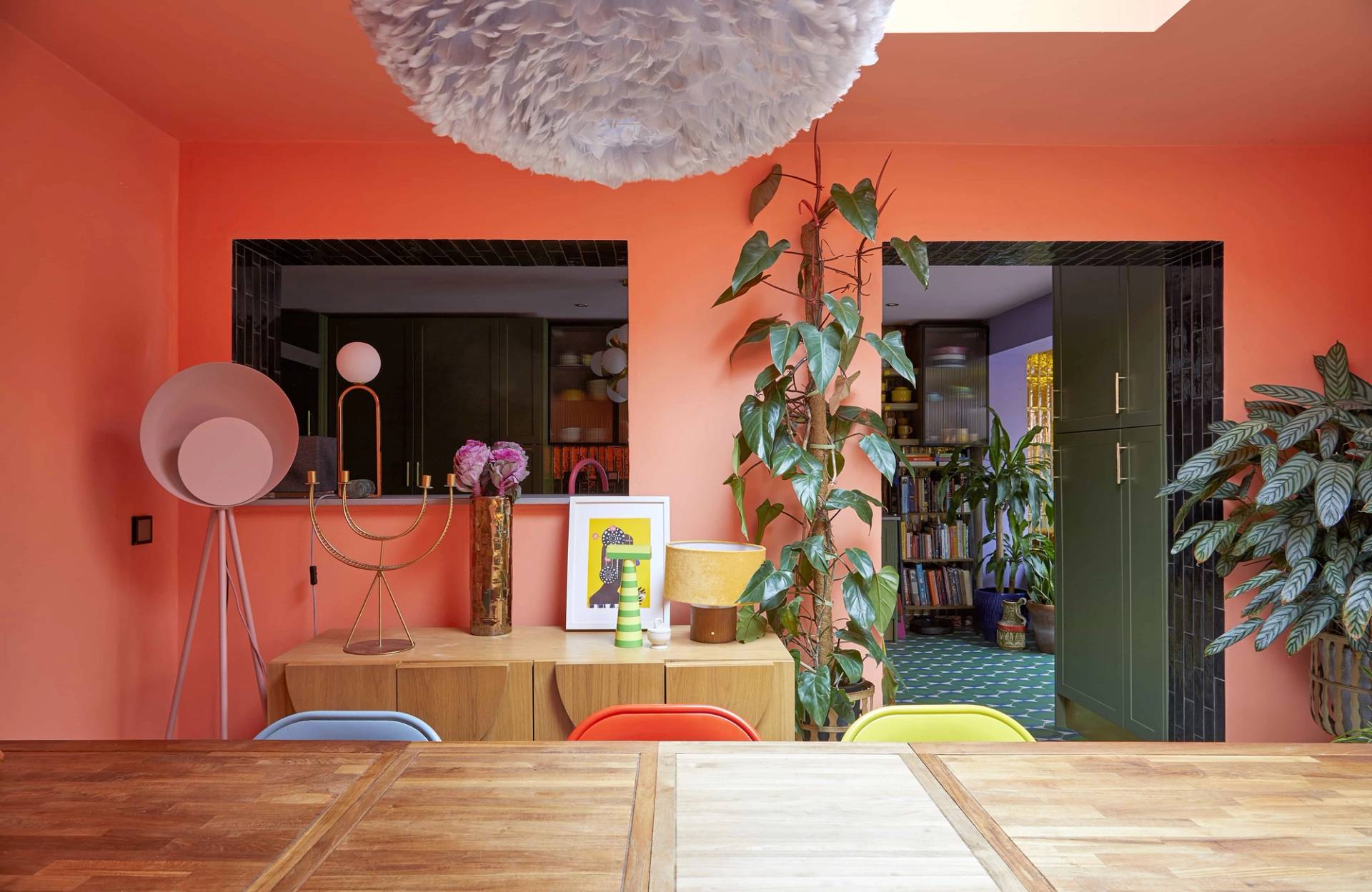 Coral dining room looking back toward the kitchen through an internal server window, Love Locations SE6.