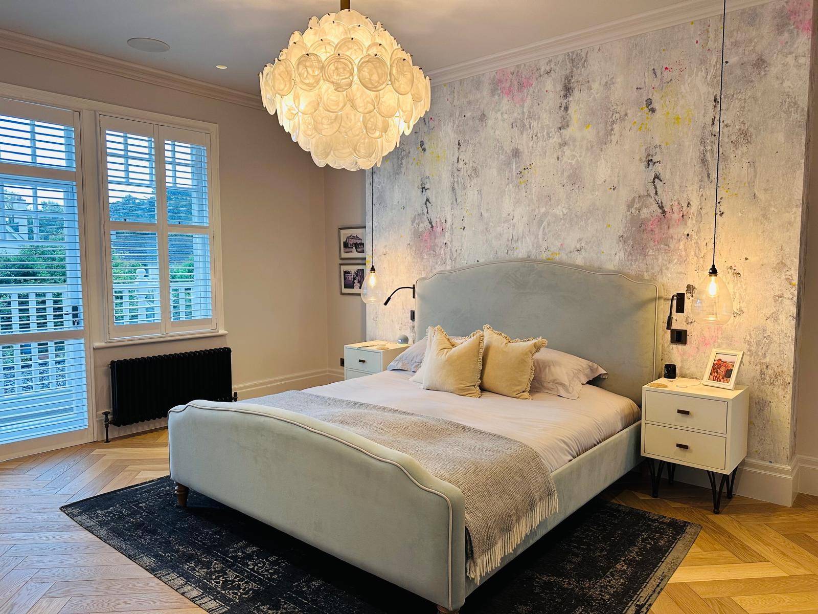 Master bedroom suite with a upholstered bed frame, globe pendant light, and floral wall mural, Love Locations TW11.