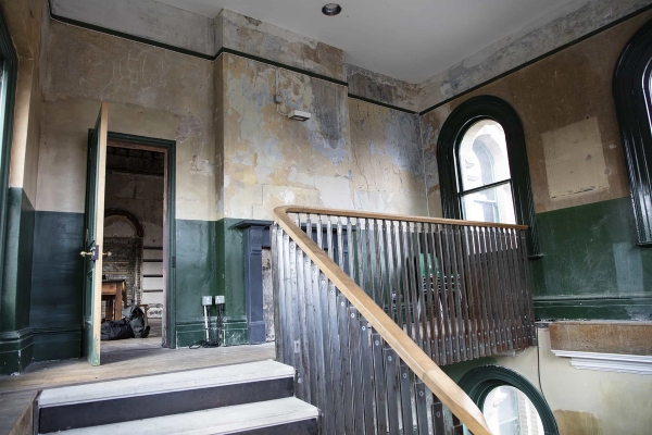 Atmospheric abandoned staircase leading to the Old Waiting Room in Peckham Rye station, available through Love Locations for hire as an event space, gallery, or filming location.