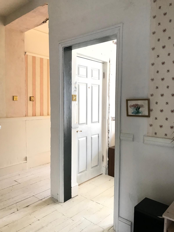 Characterful hallway junction showing mixed wallpaper designs and a classic white panelled interior door, perfect for location scouts seeking raw charm, Love Locations.