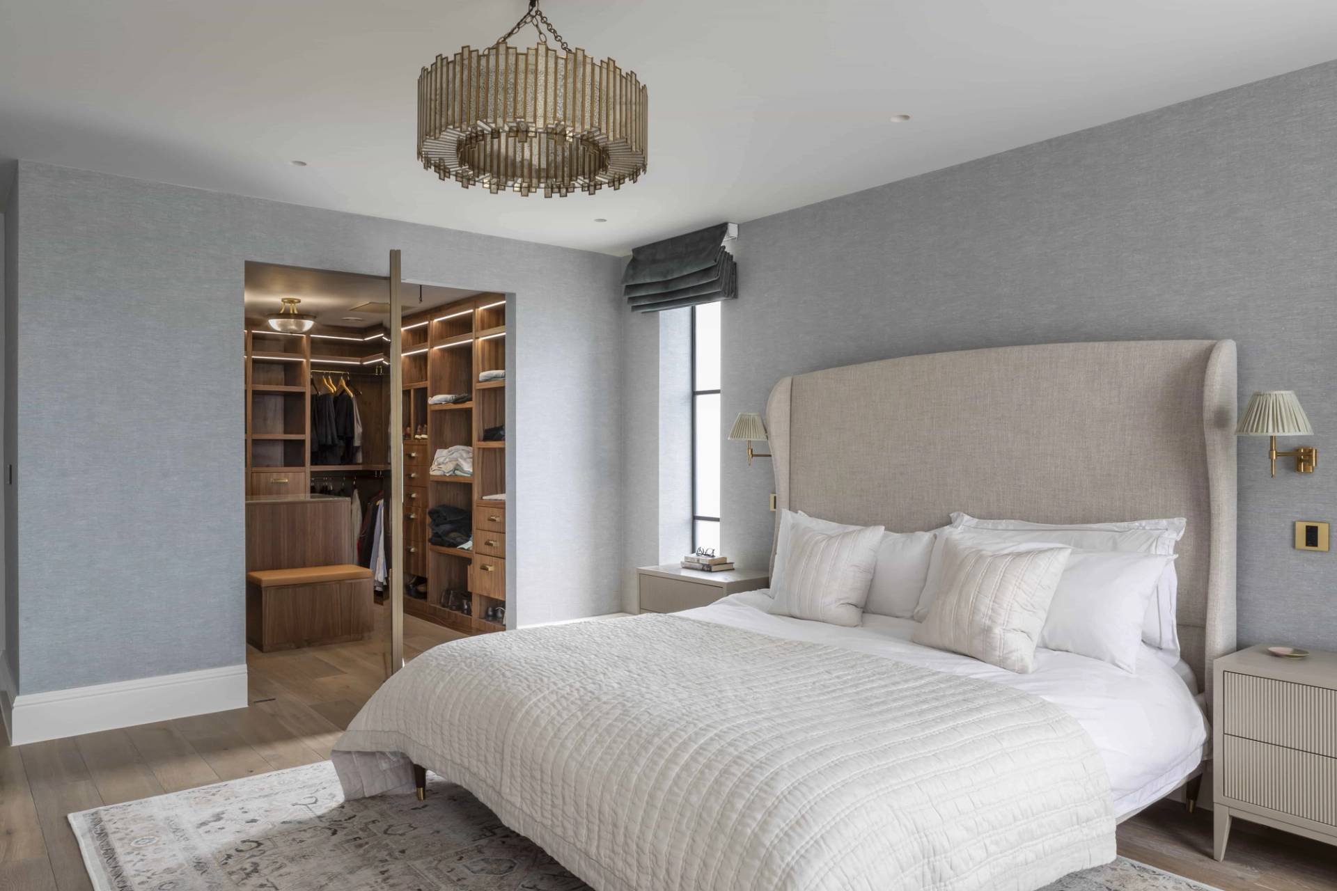 Master bedroom suite with a tall upholstered headboard, neutral linen, and open walk-in dressing room, Love Locations HP18.