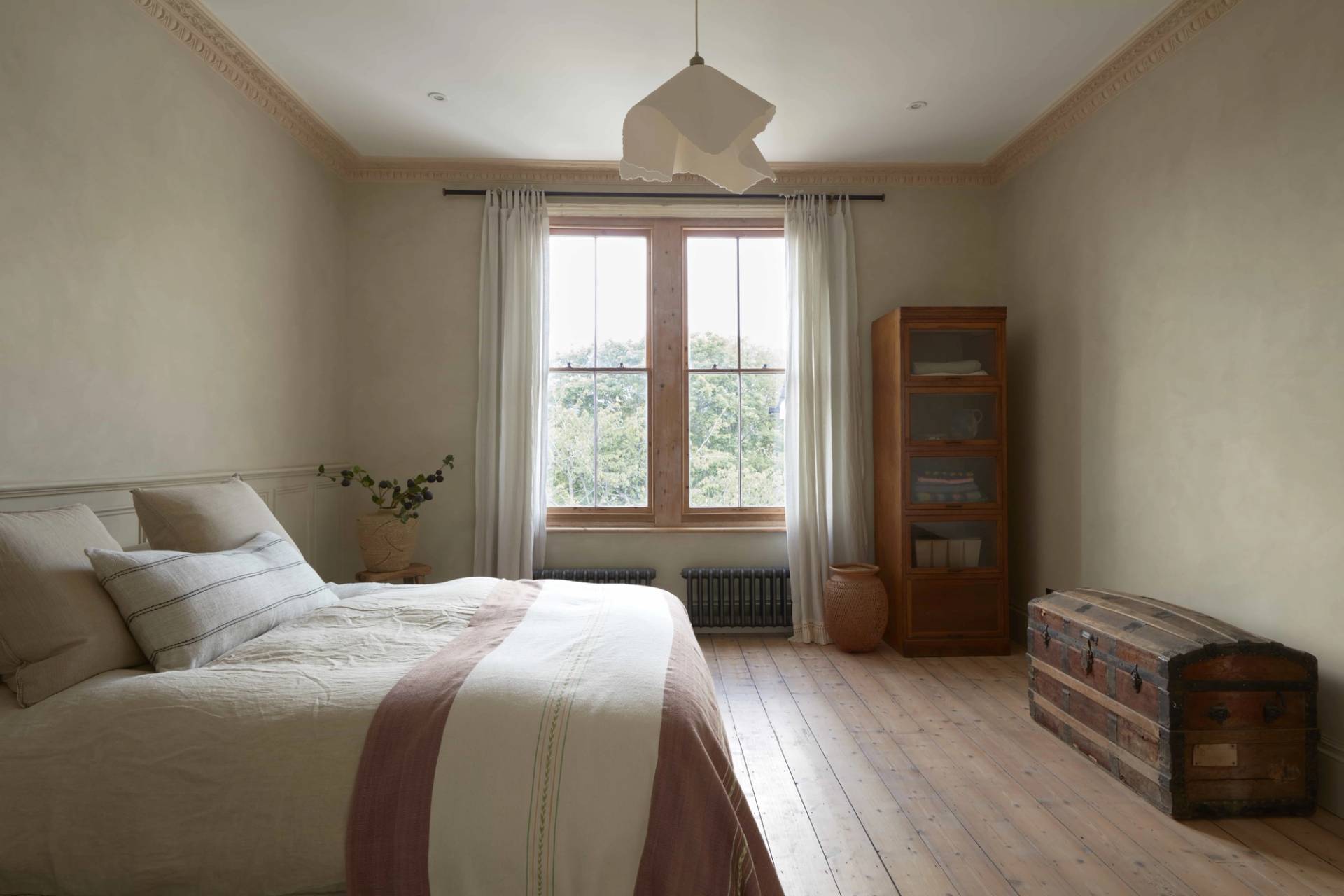 Bright bedroom featuring a large timber sash window, linen curtains, and a tall wooden cabinet, Love Locations TN34.