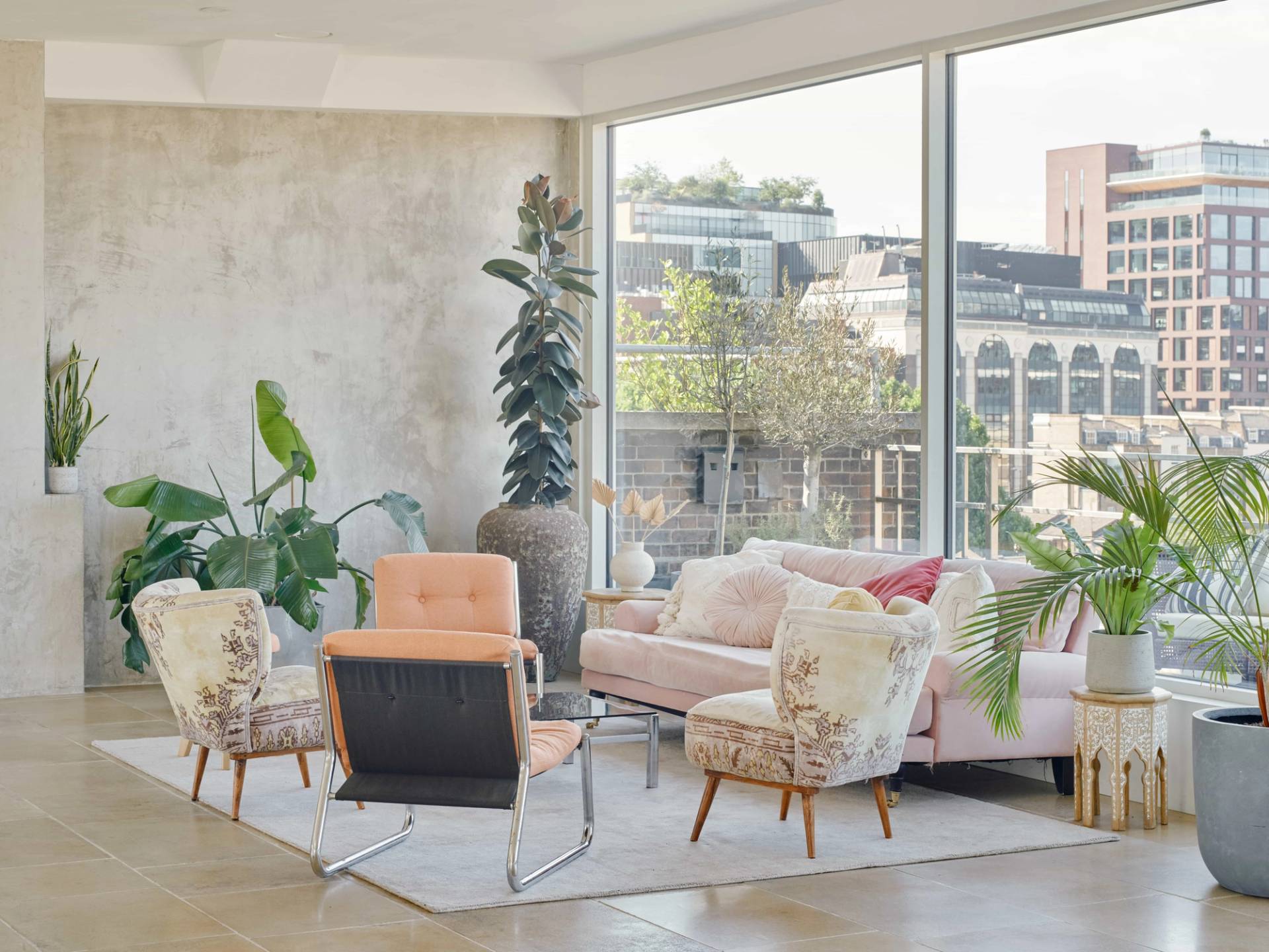 Contemporary lounge corner at THE PENTHOUSE SE1 with natural light and city views.