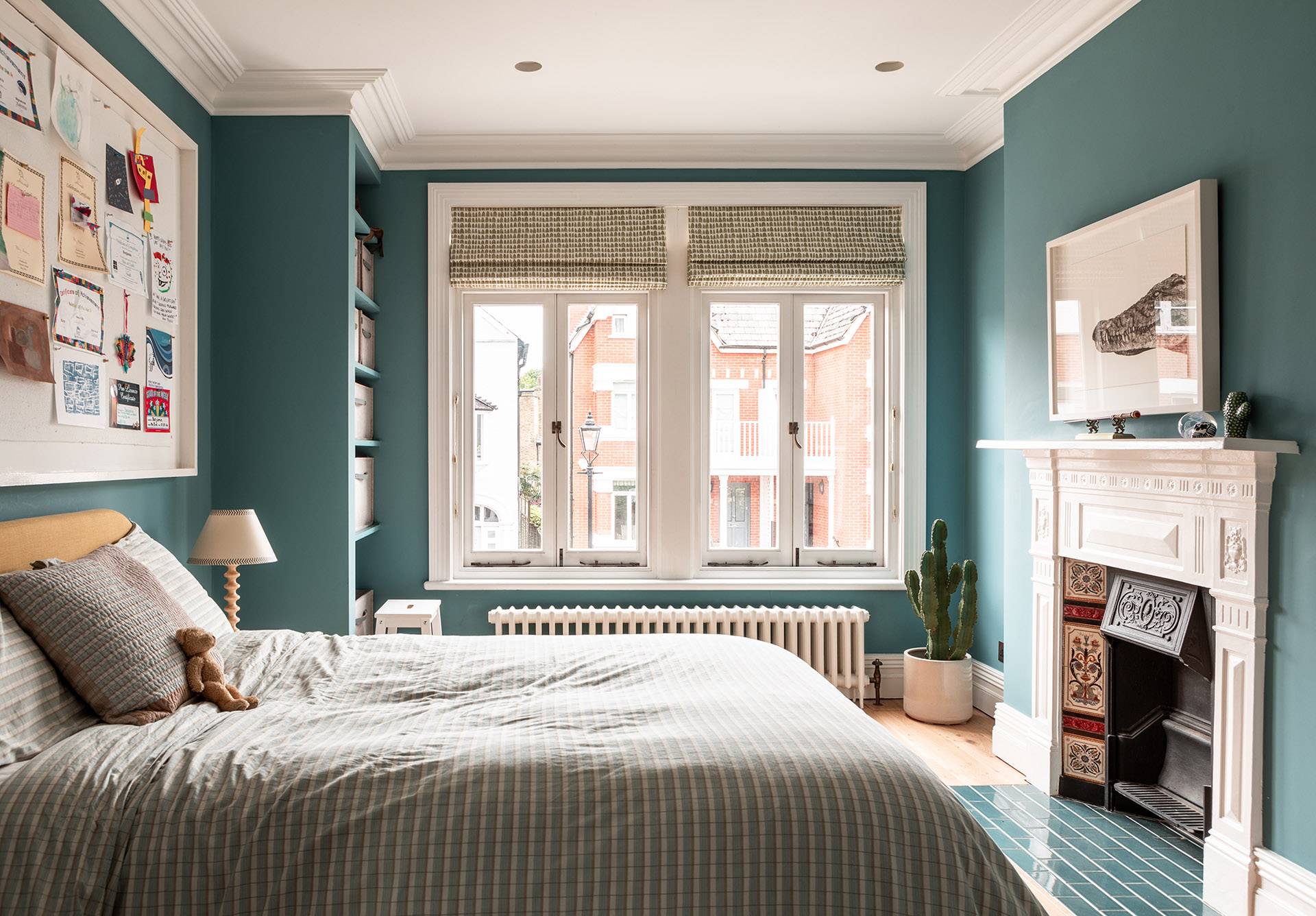 Charming kids or guest bedroom layout with teal accent walls and built-in shelving, Love Locations TW1.
