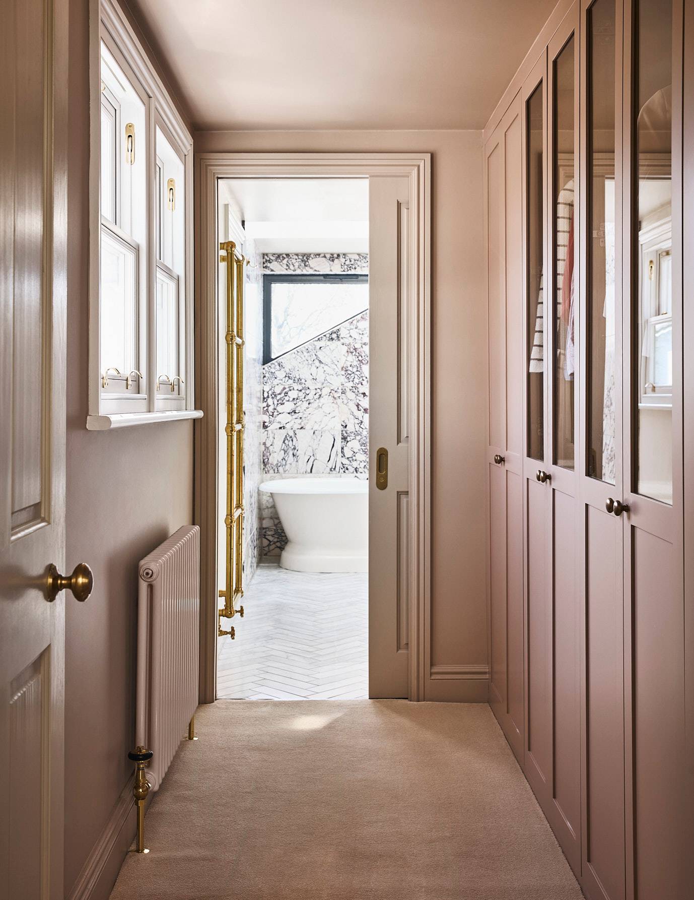 Dressing room hallway view looking through an open door into a marble master bathroom suite, Love Locations SE21.