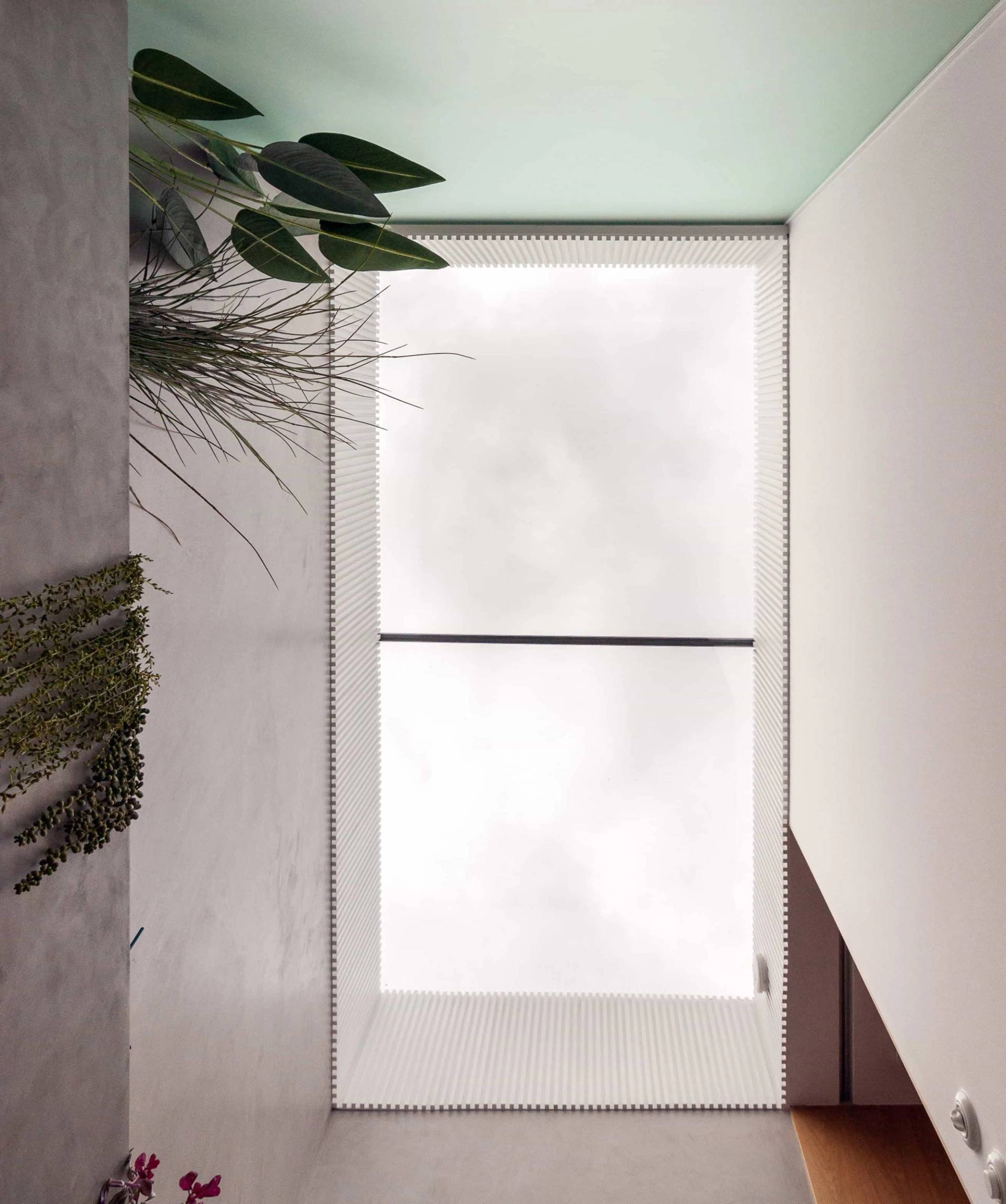 Interior door with frosted privacy glass and soft green ceiling accents in Hackney London N16 from Love Locations.