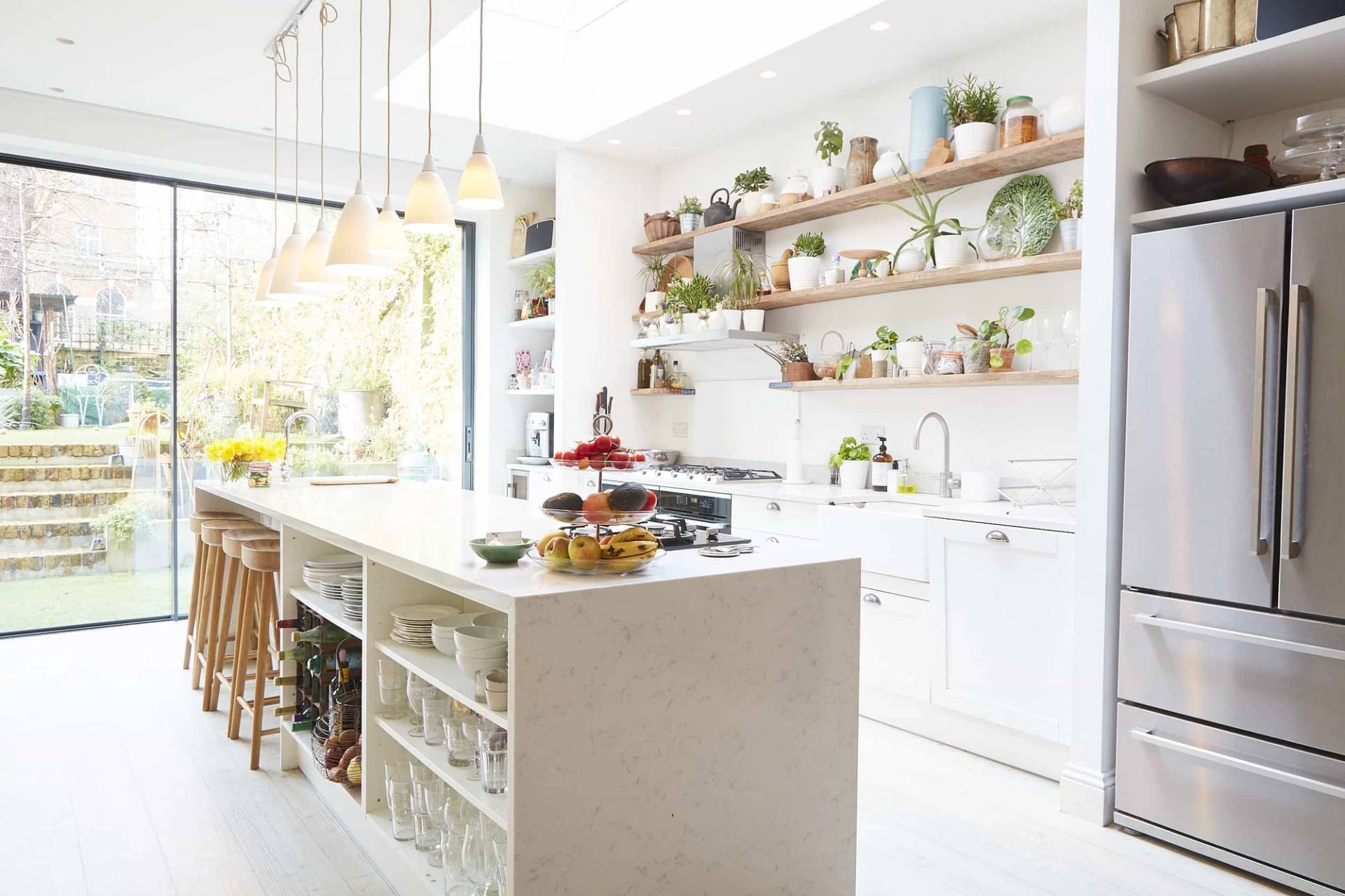 Scandi-style kitchen featuring open timber wall shelves, white cabinetry, terrazzo island, and overhead pendant lights, ideal for culinary ads, Love Locations N5.