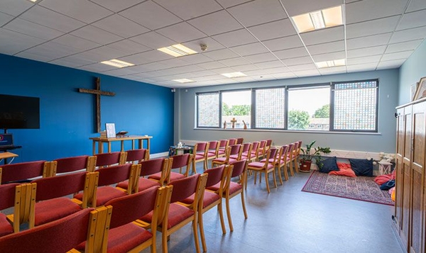Love Locations institutional chapel shoot space London SE2: Quiet multi-faith sanctuary with expansive side windows and rows of neat seating, perfect for documentaries and lifestyle photography.