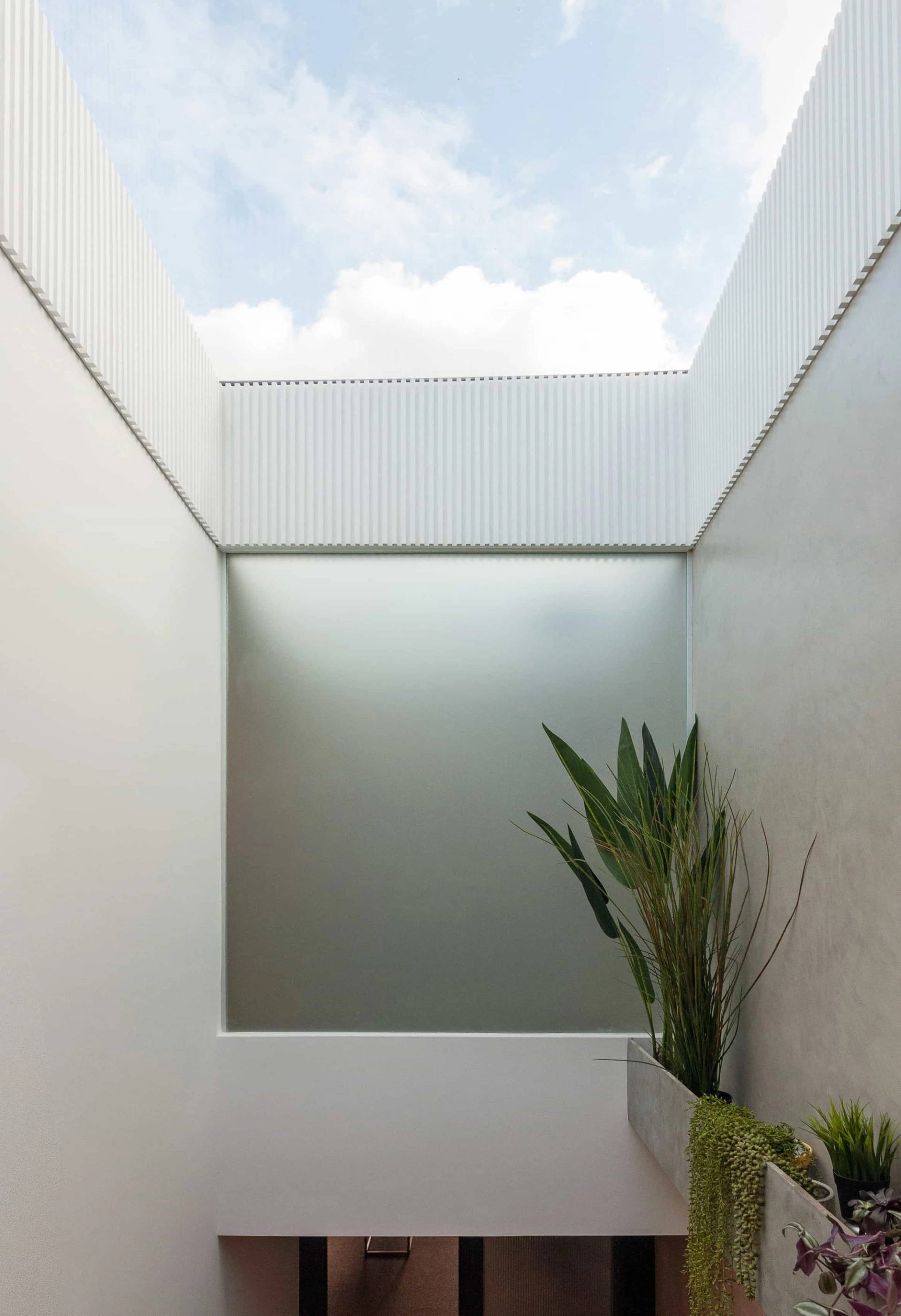 Skylight window feature over smooth plastered walls in a minimalist London shoot location in Hackney N16 via Love Locations.