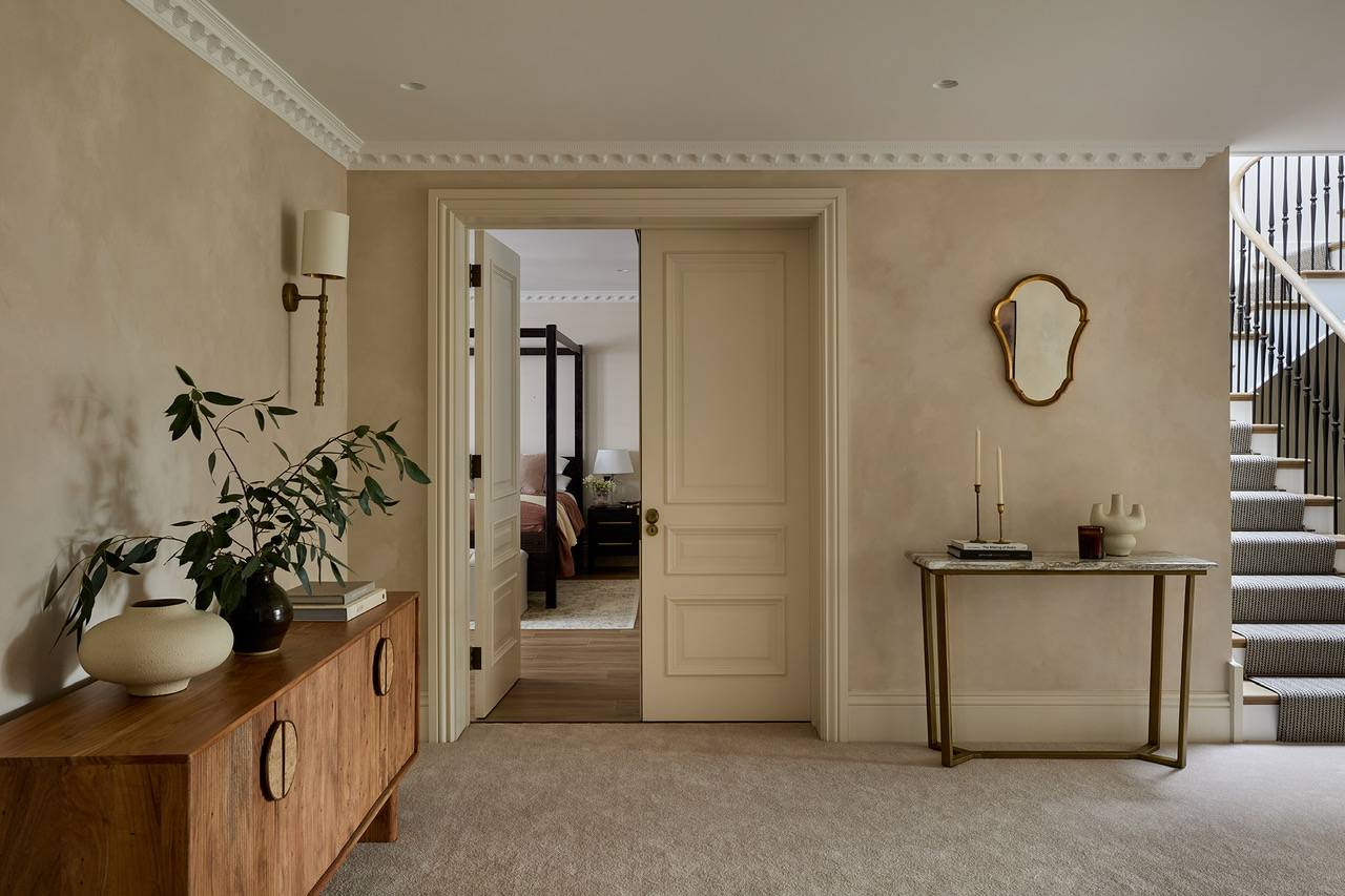 Interior viewpoint looking through classic double pocket doors into a grand bedroom suite, ideal for traditional British drama filming, Love Locations.