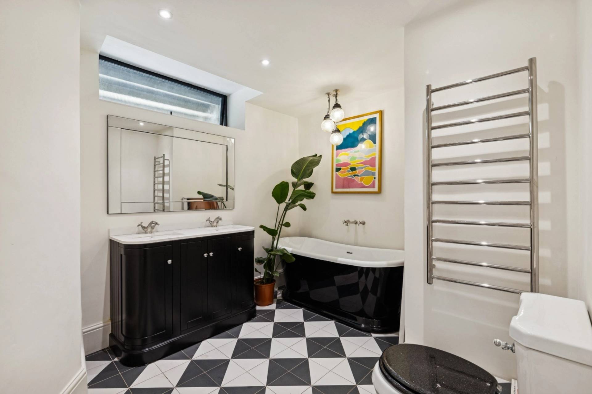 Modern luxury bathroom featuring black and white checkerboard tiled floors in Hampstead through Love Locations.