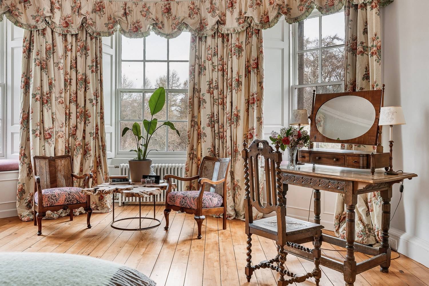 Period dressing table nook set beside large sash windows with floral drapery, Love Locations KY15.