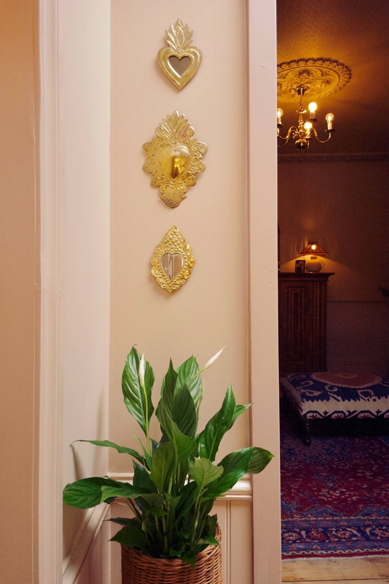 Stylized hallway wall featuring gold decorative wall sconces and a large green potted houseplant, perfect for luxury interior backdrops, Love Locations TW7.