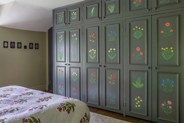 Glenstriven guest bedroom featuring hand-painted wardrobe panels with floral motifs in historic country house.