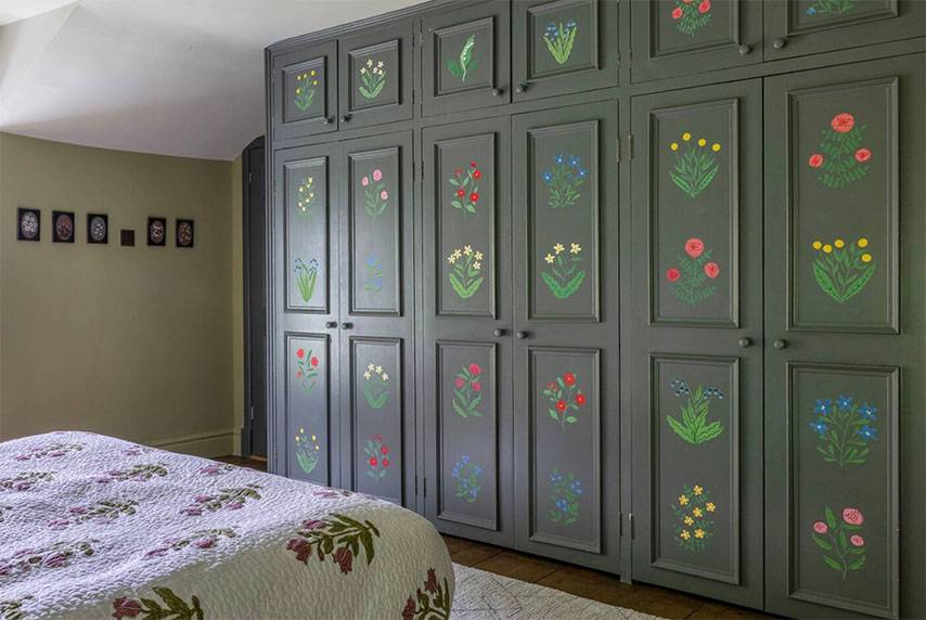 Glenstriven guest bedroom featuring hand-painted wardrobe panels with floral motifs in historic country house.
