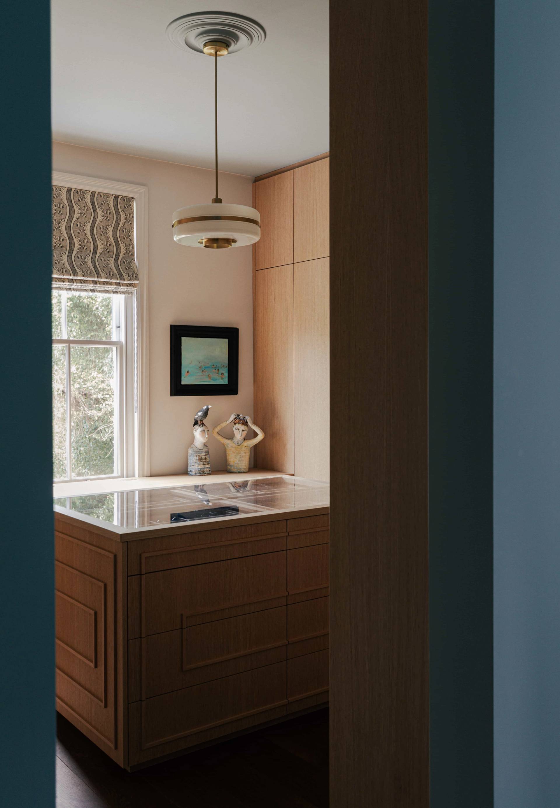 Custom walk-in closet room featuring light wood cabinetry and central display drawers, ideal for fashion brand filming, Love Locations SW13.