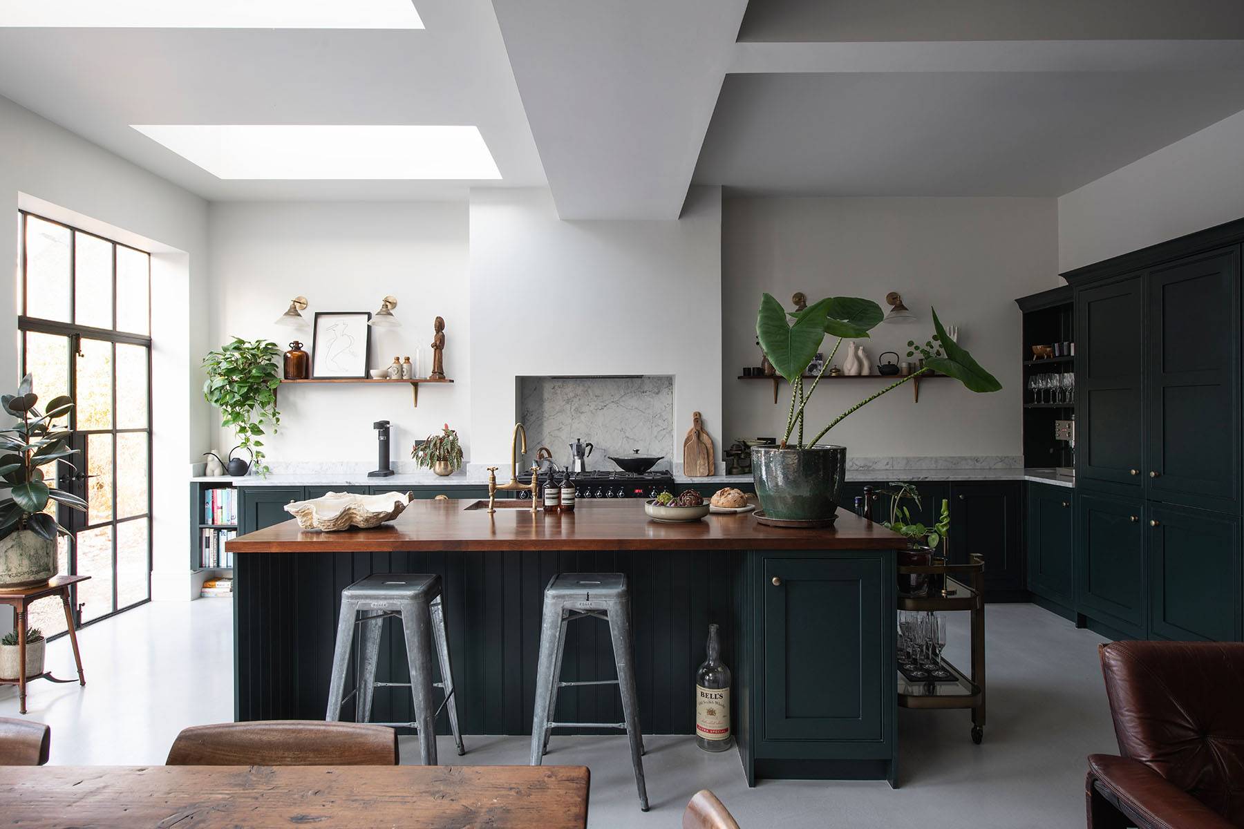 Industrial kitchen island with bar stool seating set under overhead skylights in South London, ideal for culinary video ads, Love Locations SW16.