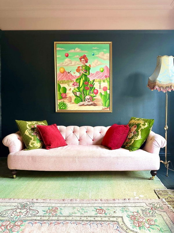 Dark green living room featuring a plush pink tufted chesterfield sofa and vibrant artwork, Love Locations N13.