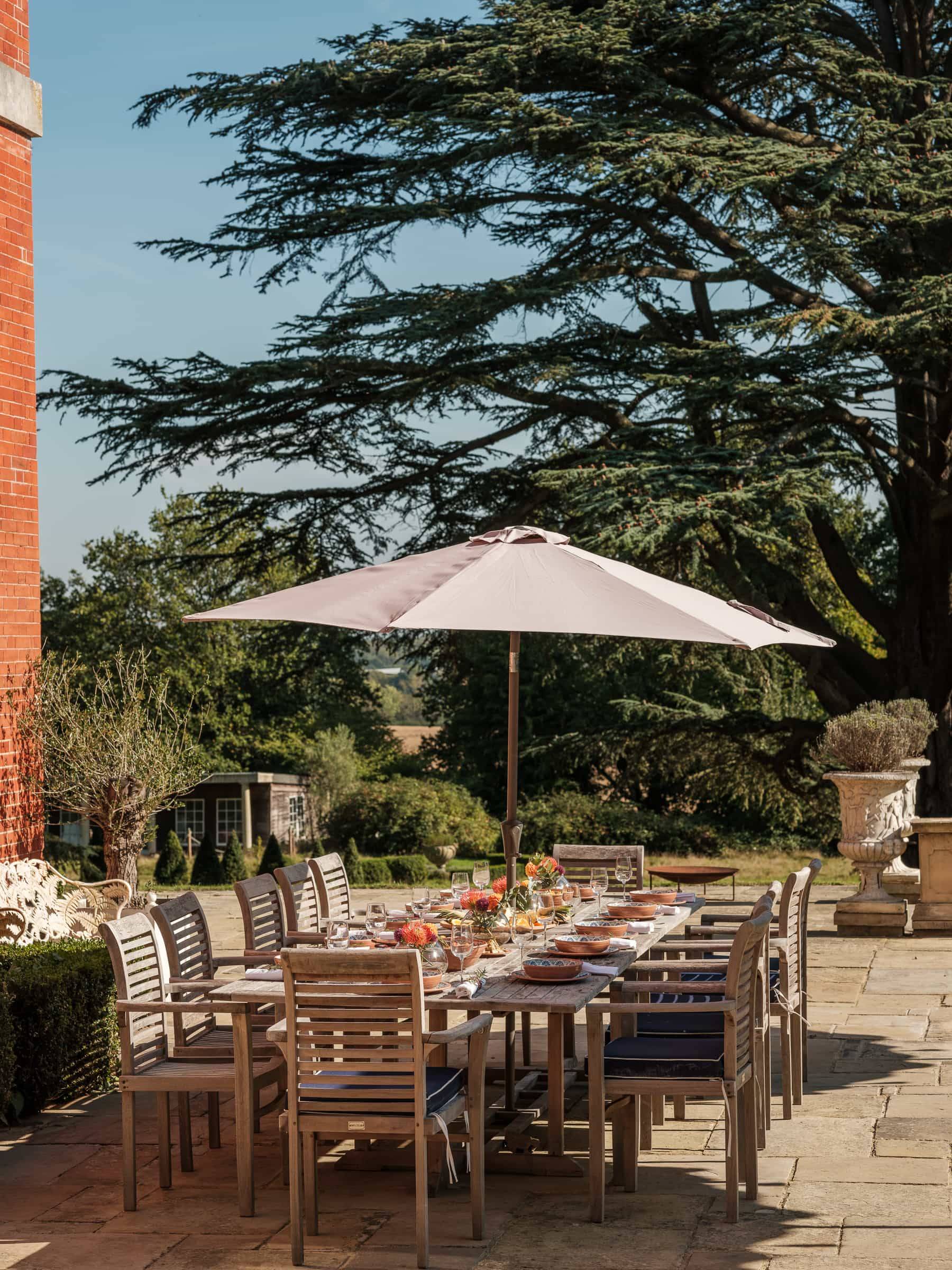 Outdoor dining table arrangement set up on a stone terrace for commercial lifestyle shoots, Love Locations RG42.