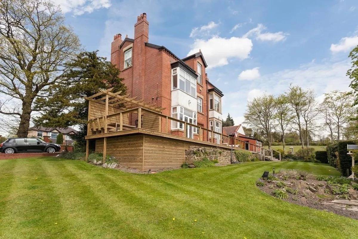 Large rear lawn and elevated multi-level wooden decking on a detached location home in Stockport SK6 from Love Locations.
