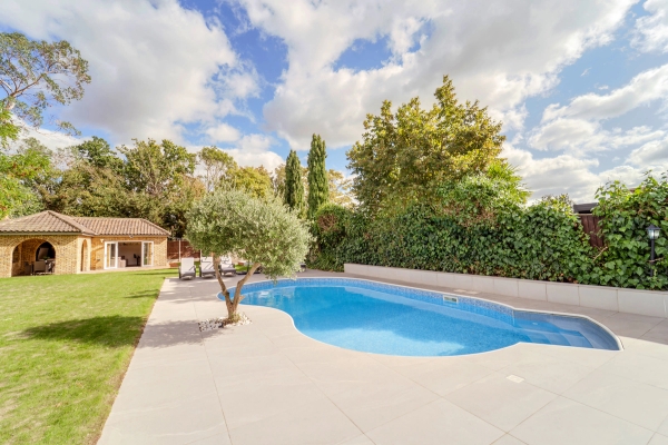 Heated outdoor swimming pool with paved stone terrace on a luxury estate in Emerson Park, Love Locations RM11.