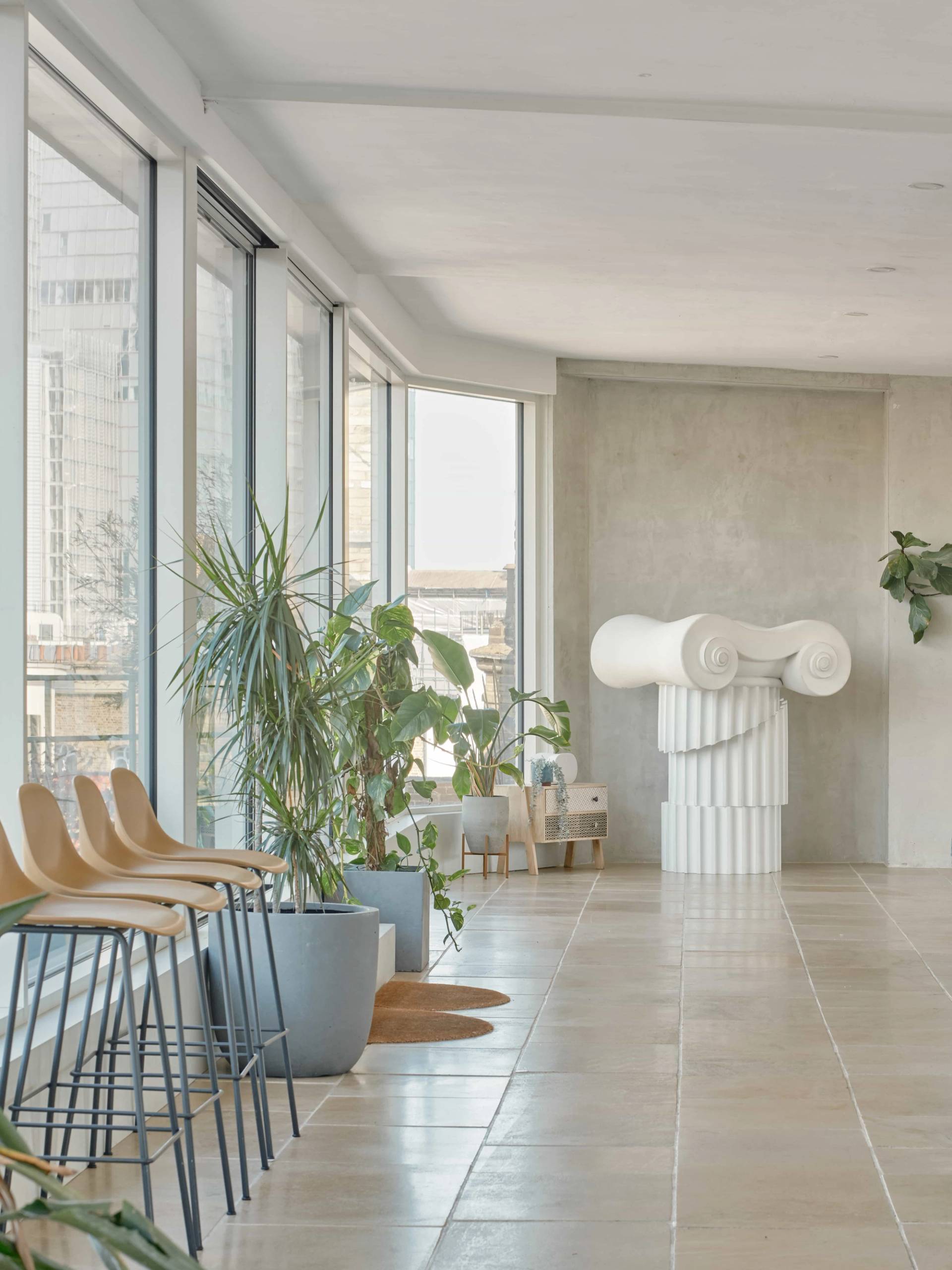 Cosy seating nook with soft furnishings and window light in The Penthouse – SE1.