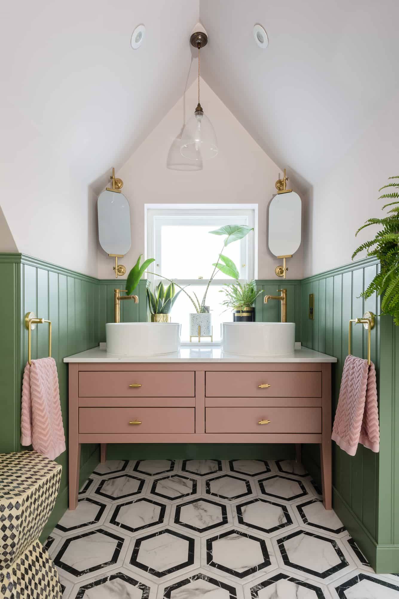 Double vanity bathroom unit featuring twin vessel sinks, pink cabinet, and sage green wall panelling, Love Locations TW11.