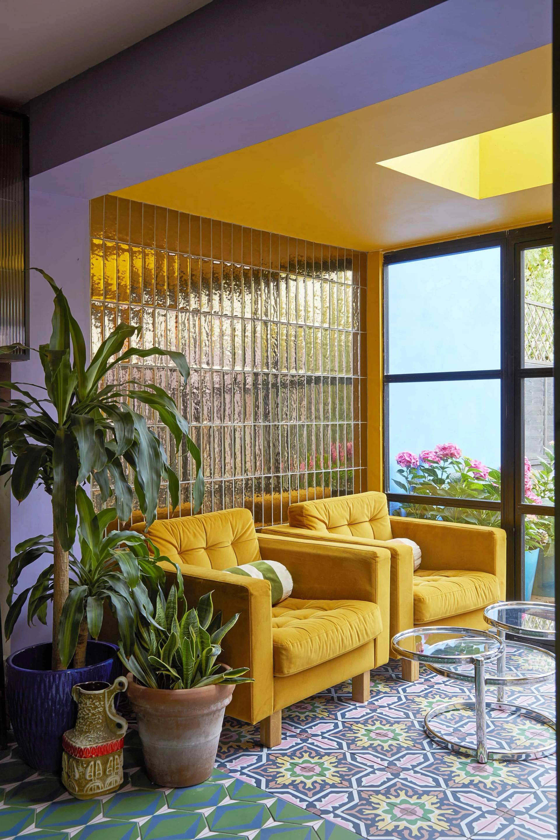Bright yellow sunroom nook with metallic tile splashback wall and twin yellow armchair seating, Love Locations SE6.