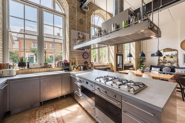 Modern stainless steel commercial-style kitchen inside a converted school conversion location in Elephant and Castle, via Love Locations.