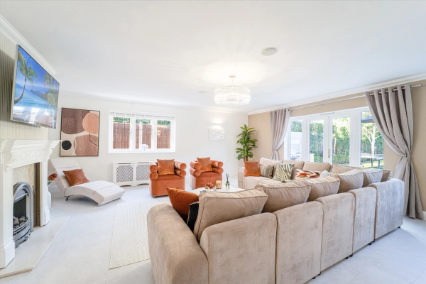 Spacious family lounge featuring tan velvet armchairs, neutral sectional couch, and double windows, Love Locations RM11.