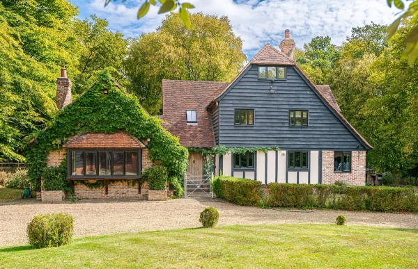 Front elevation of modern barn surrounded by trees in Essex, Love Locations