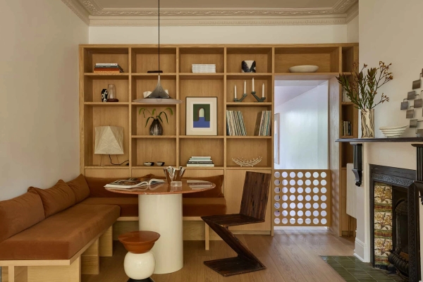 Love Locations bespoke library location Lewisham: Symmetrical view of floor-to-ceiling custom oak bookshelves framing an integrated dining nook, ideal for intellectual or corporate media backdrops.